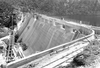 View of Mullardoch-Fasnakyle-Affric Project, contract no 10, Benevean Dam. Downstream face of dam from north bank.
Scan of glass negative no. 306, Box 1042/1