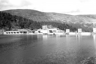 View of Mullardoch-Fasnakyle-Affric Project, contract no 10, Benevean Dam. Bridge and gatehouse under construction, view from south bank.
Scan of glass negative no. 303, Box 1042/1