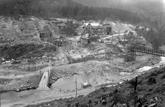 View of Mullardoch-Fasnakyle-Affric Project, contract no 10, Benevean Dam, downstream view from south bank, showing concreting in north half.
Scan of glass negative no. 125, Box 1103/2