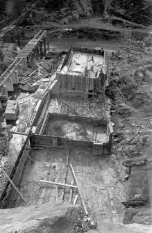 View of Mullardoch-Fasnakyle-Affric Project, contract no 10, Benevean Dam, view along  centre line from north bank, showing concrete in blocks 11, 12 and 13.
Scan of glass negative no. 137, Box 1103/2