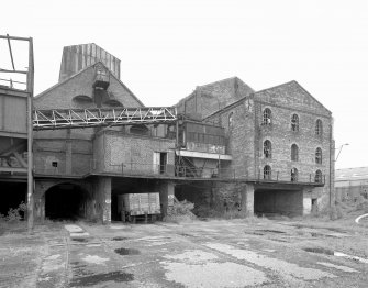 Newtongrange, Lady Victoria Colliery, Old Washer Plant
View from SW of S gables of brick-built Hopper (Left) and Old Washer (right), prior to restoration.  The view also shows the railway lines emerging from the lower level of the pit-head complex.