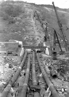 Loch Sloy Project, Contract 13 - Exterior steel pipeline. View looking upwards to Valve House.
Scanned image of glass negative no. 2, Box 1115.