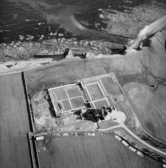 Oblique aerial photograph showing old and new castles and nissen huts