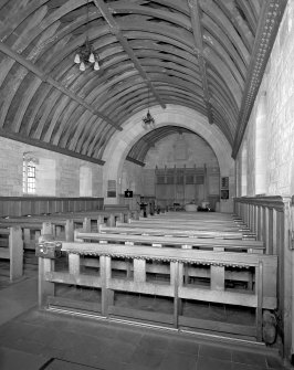 Interior. View from WSW showing timber roof, fornishings and chancel arch