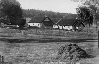 Historic photograph showing view of cottages.