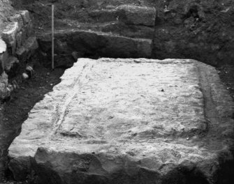Excavation photograph showing large block at corner of courtyard, taken during the James Curle excavation 1905-1909.