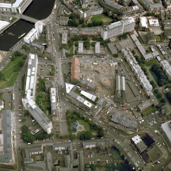 Oblique aerial view centred on the excavation of the Black Vaults, Edinburgh, with the warehouses and offices adjacent, taken from the SW.