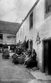 Modern copy of historic photograph showing view of 1-9 and 4-8 Castle Street with village folk in foreground.