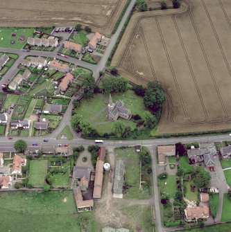 Scanned image of oblique aerial photograph of East Saltoun centred on theParish Church and Graveyard, taken from the NE.