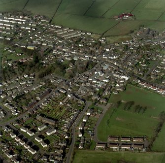 Oblique aerial view of the town centred on the church, taken from the SW.