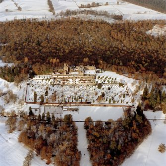 Oblique aerial view of Drummond Castle in the snow, taken from the South South-East, taken in 1996.