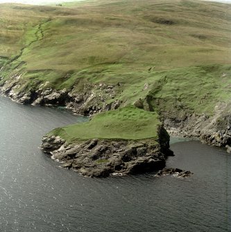 Oblique aerial view centred on the remains of the monastic settlement, taken from the E.