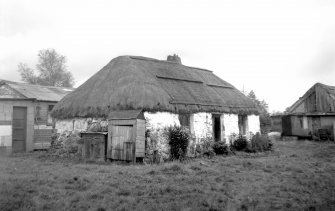 Scanned image of view of thatched cottage, and barn