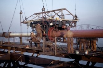 Cable wrapping machine on downstream cable at mid-span. Machine stabilised by 4 tackles to tram support strands.
Copy of original 35mm colour transparency.
Survey of Private Collection