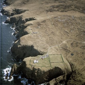 Oblique aerial view centred on Cape Wrath lighthouse, keepers' cottages, cottages and support buildings with the radar station adjacent, taken from the NW.