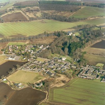 Oblique aerial view centred on Monymusk village with the tower-house in the background, taken from the SW.
