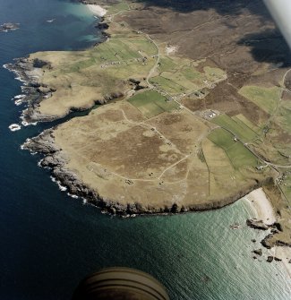 General oblique aerial view centred on the crofting townships, cave and the remains of the radar station, taken from the NW.