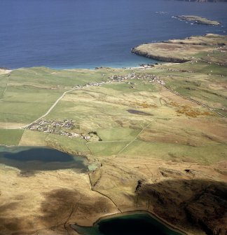 Oblique aerial view looking across the village towards the crofting township and radar station, taken from the WSW.