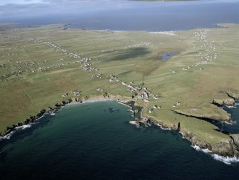 General oblique aerial view looking across the harbour, crofting township and lazy beds towards the townships, taken from the ESE.