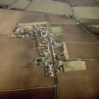 General oblique aerial view centred on the village with the building and farmsteading adjacent, taken from the W.