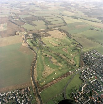 Oblique aerial view centred on the golf course, club house and walled garden, taken from the W.