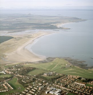 General oblique aerial view looking across the school, club house and Belhaven Bay towards North Berwick Law, the Firth of Forth and the Bass Rock, taken from the ESE.