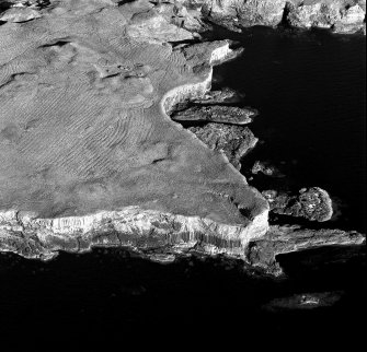 Scanned image of oblique aerial view of Staffa, taken from the north west, centred on building remains.