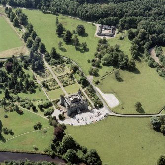Oblique aerial view centred on the country house and garden with farmhouse, farmsteading and stables adjacent, taken from the ENE.