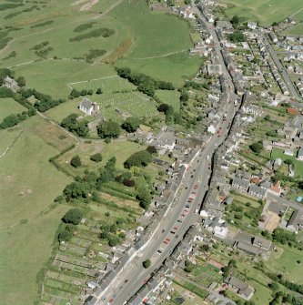 Oblique aerial view of Whithorn centred on the church, burial ground and the remains of the priory, taken from the SSW.