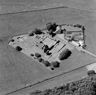 Oblique aerial view centred on the remains of the abbey and abbot's house, taken from the E.