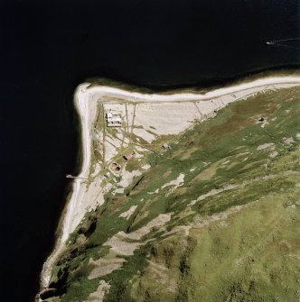 Oblique aerial view centred on the lighthouse, cottages and foghorn with the remains of the castle adjacent, taken from the NW.