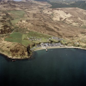 Oblique aerial view centred on the whisky distillery, housing and schoolhouse, taken from the NE.
