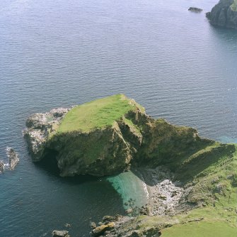 Scanned image of oblique aerial view centred on the remains of the monastic settlement, taken from the NNW.