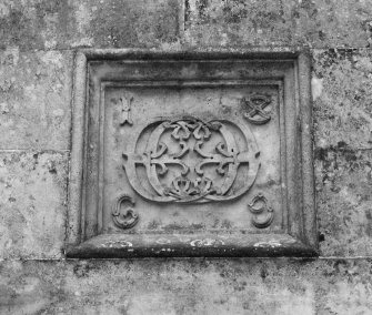 Entrance, carved panel containing monogram dated 1869, detail