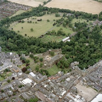 Oblique aerial view centred on Dunfermline Abbey, with the town hall, library and Abbots House adjacent, taken from the NE.