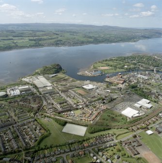 General oblique aerial view of Dumbarton looking across the works, football ground, castle, whisky distillery and the River Clyde towards Langbank, taken from the NE.