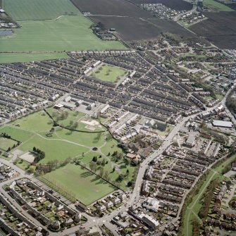 Oblique aerial view centred on the village and miners' rows, taken from the NW.