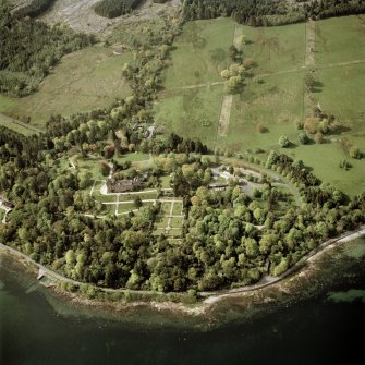 Oblique aerial view centred on the country house, walled garden and cottages, taken from the SE.