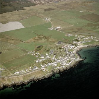 Oblique aerial view centred on the village with the farmstead adjacent, taken from the SSE.