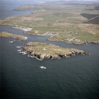 General oblique aerial view centred on the villages, lighthouse, cottage and remains of the chapel and burial ground, taken from the SSW.
