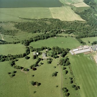 Oblique aerial view of the country house with dovecot, farmsteading and remains of the flour mill adjacent, taken from the SSW.