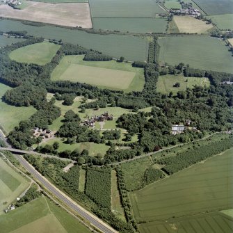 Oblique aerial view centred on the country house, with the farmsteading and the gate-lodge adjacent, taken from the NNW.