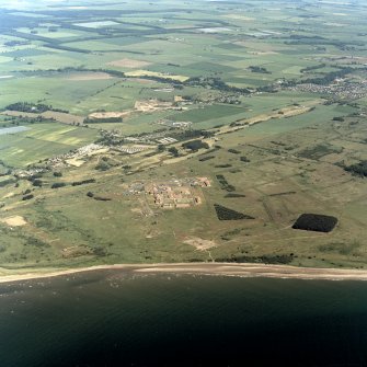 Scanned image of oblique aerial view of the western part of the Barry Buddon Training Range.  Visible is the main camp with one small arms range and the early 20th Century gun battery.