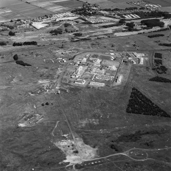 Scanned image of oblique aerial view of Buddon Camp with the early 20th Century gun battery in the foreground.  Also visible is the modern main camp, 19th Century gunnery room and other ancilliary buildings.