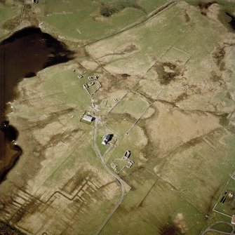 Oblique aerial view centred on the remains of the farmsteads and the houses, taken from the SSE.