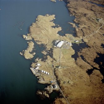 Oblique aerial view centred on the power station, with the jetty and township adjacent, taken from the NW.