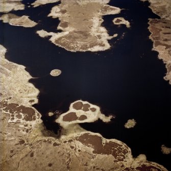 Oblique aerial view centred on the remains of the duns, taken from the S.