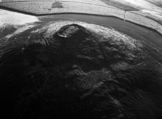 Oblique aerial view centred on the remains of the vitrified fort at Tap O' Noth, looking to the WNW.