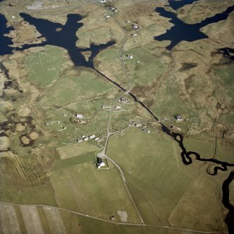 Oblique aerial view centred on Howmore township, South Uist, with the church and the remains of the churches and the chapels adjacent, taken from the WNW.