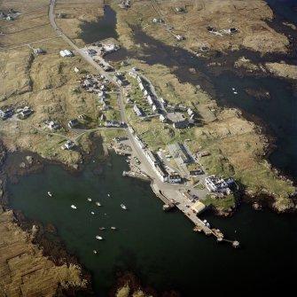 Oblique aerial view centred on Lochboisdale village, South Uist, with the pier, the school, the church and the hotel adjacent, taken from the SSE.